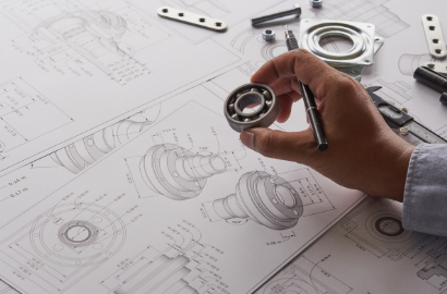 Apprentice in metalworking looking at workpiece being satisfied